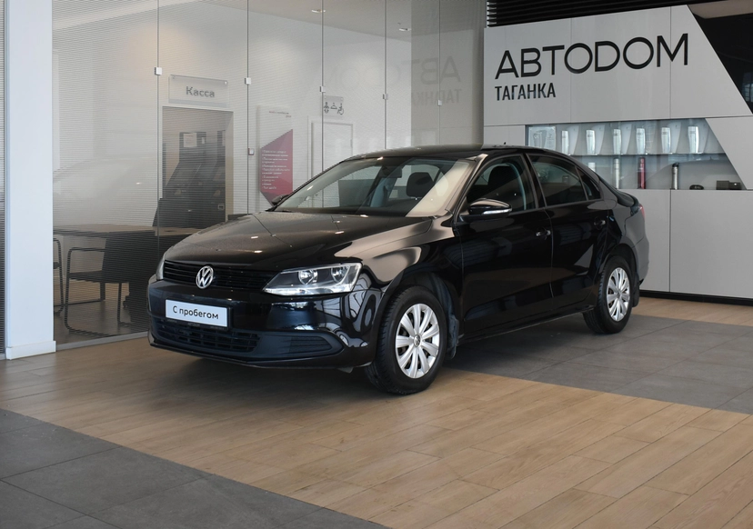 Автомобиль Volkswagen Jetta VI поколение 1.6 AT (105 л.с.) Trendline Чёрный 2013 с пробегом 117 568 км